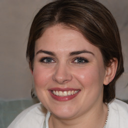 Joyful white young-adult female with medium  brown hair and blue eyes