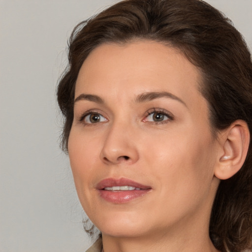 Joyful white adult female with medium  brown hair and brown eyes