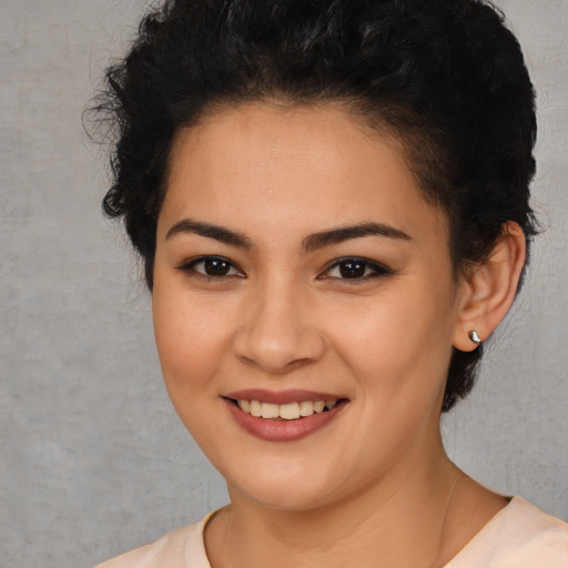 Joyful latino young-adult female with short  brown hair and brown eyes
