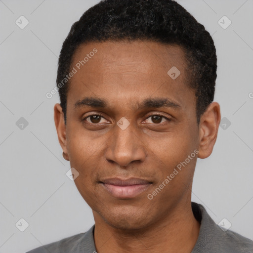 Joyful black young-adult male with short  black hair and brown eyes