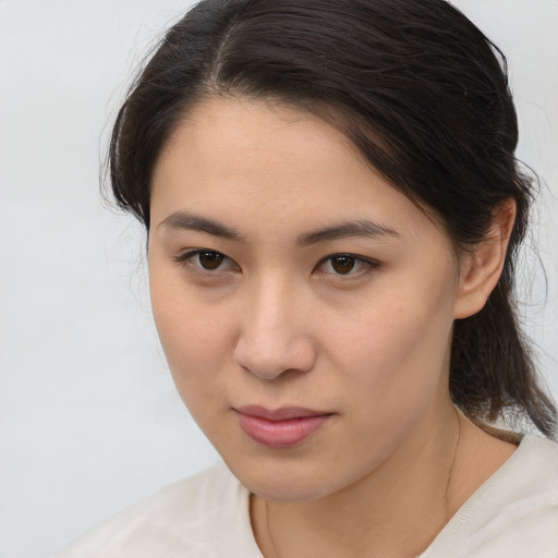 Joyful asian young-adult female with medium  brown hair and brown eyes