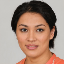 Joyful latino young-adult female with medium  brown hair and brown eyes