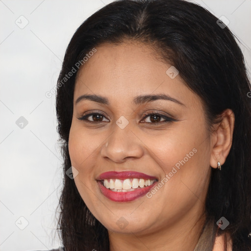 Joyful latino young-adult female with long  brown hair and brown eyes