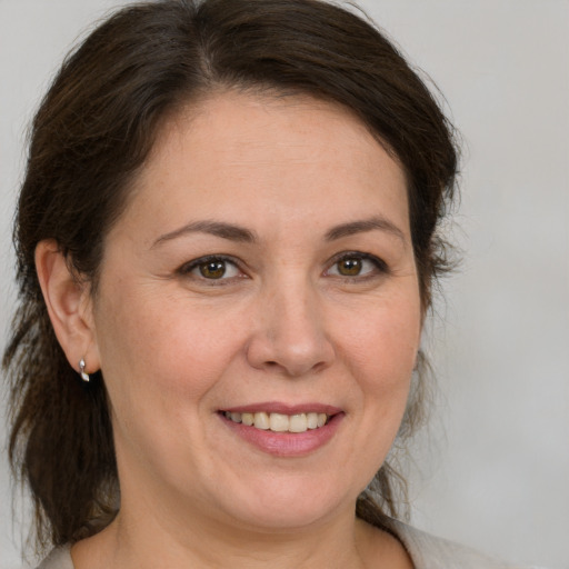 Joyful white adult female with medium  brown hair and brown eyes