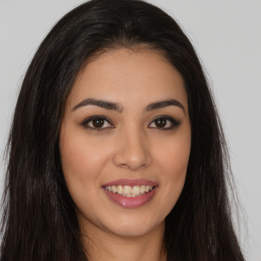 Joyful white young-adult female with long  brown hair and brown eyes