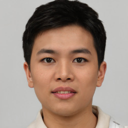 Joyful asian young-adult male with short  black hair and brown eyes