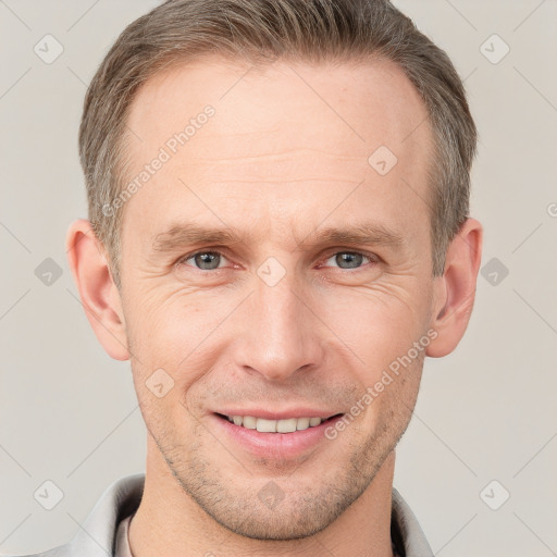 Joyful white adult male with short  brown hair and grey eyes