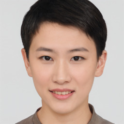 Joyful asian young-adult female with short  brown hair and brown eyes