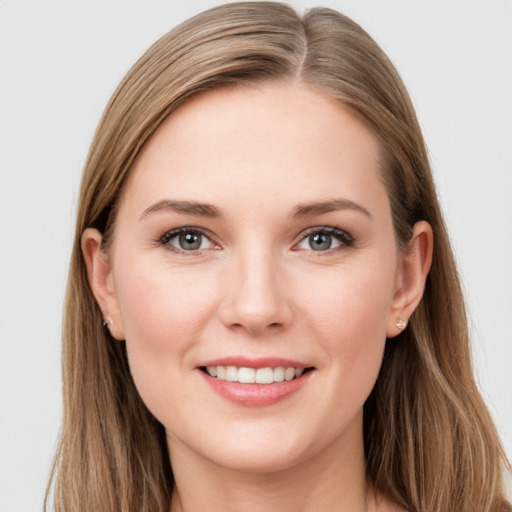 Joyful white young-adult female with long  brown hair and grey eyes