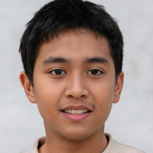 Joyful asian child male with short  brown hair and brown eyes