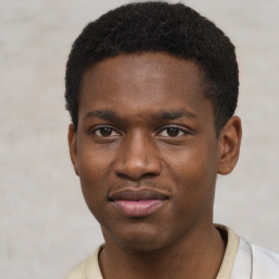 Joyful black young-adult male with short  black hair and brown eyes