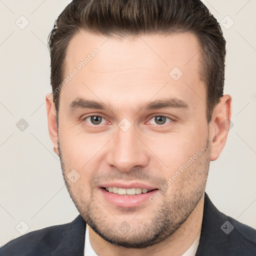 Joyful white young-adult male with short  brown hair and brown eyes