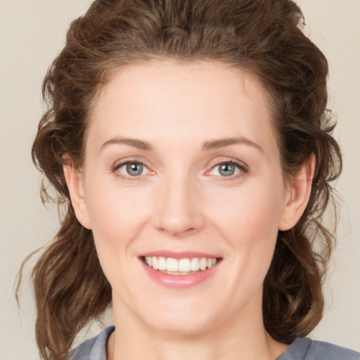 Joyful white young-adult female with medium  brown hair and green eyes