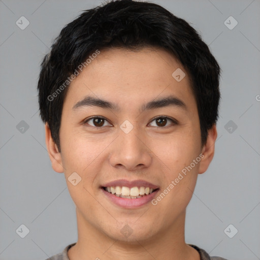 Joyful asian young-adult male with short  brown hair and brown eyes