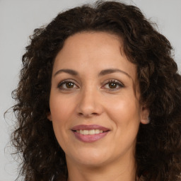 Joyful white adult female with long  brown hair and brown eyes