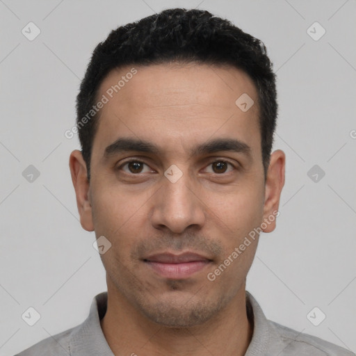 Joyful white young-adult male with short  black hair and brown eyes