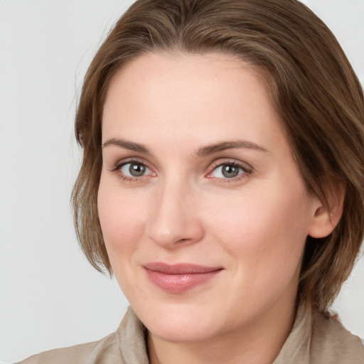 Joyful white young-adult female with medium  brown hair and blue eyes