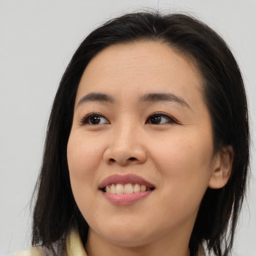 Joyful asian young-adult female with medium  brown hair and brown eyes