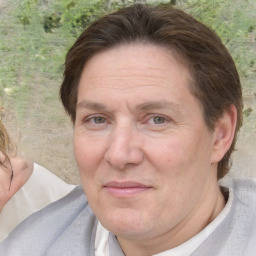 Joyful white adult male with medium  brown hair and brown eyes