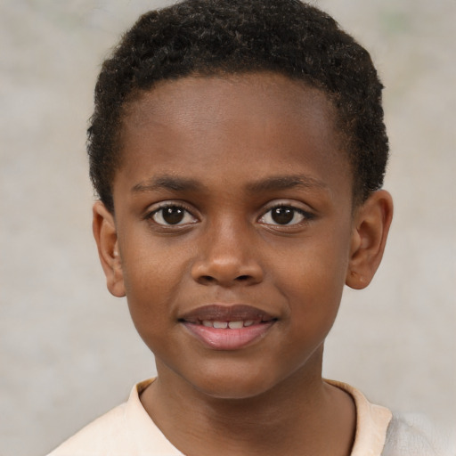 Joyful black child male with short  brown hair and brown eyes