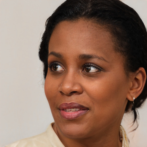 Joyful black young-adult female with medium  brown hair and brown eyes