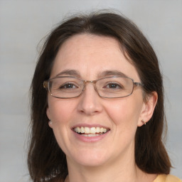 Joyful white adult female with medium  brown hair and grey eyes