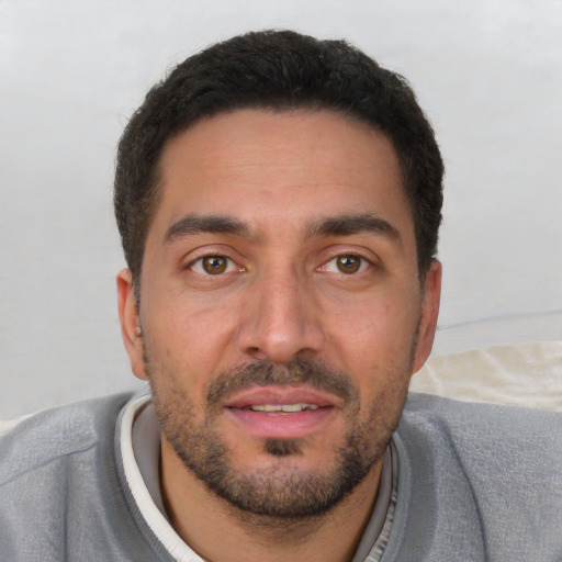 Joyful white young-adult male with short  black hair and brown eyes