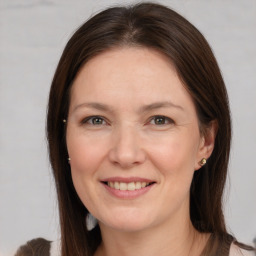 Joyful white adult female with medium  brown hair and brown eyes