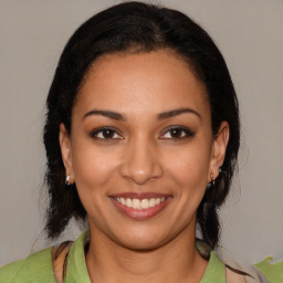 Joyful latino young-adult female with medium  black hair and brown eyes