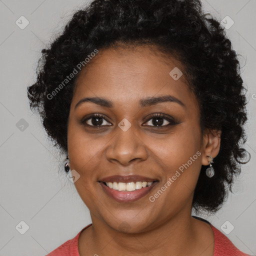 Joyful black young-adult female with long  black hair and brown eyes