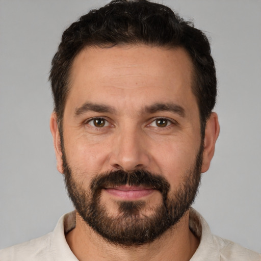 Joyful white adult male with short  brown hair and brown eyes