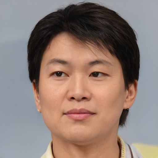 Joyful asian adult female with short  brown hair and brown eyes