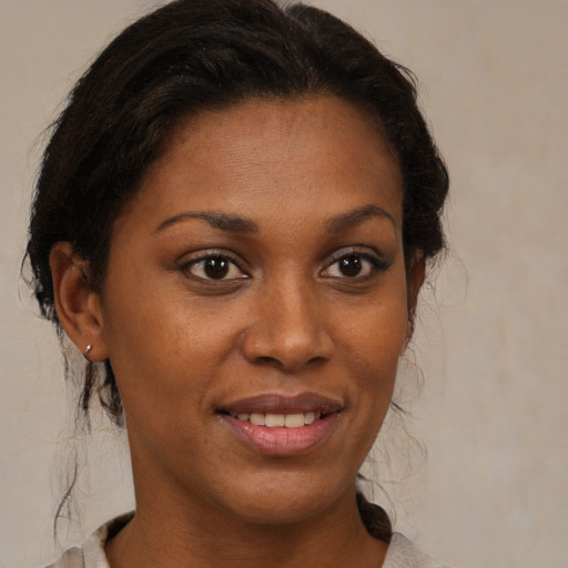 Joyful black young-adult female with medium  brown hair and brown eyes