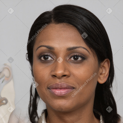 Joyful black young-adult female with long  black hair and brown eyes