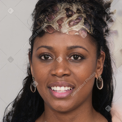 Joyful black young-adult female with long  black hair and brown eyes