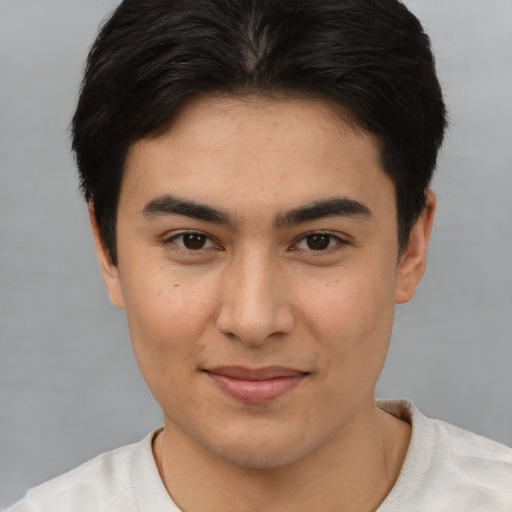 Joyful asian young-adult male with short  brown hair and brown eyes