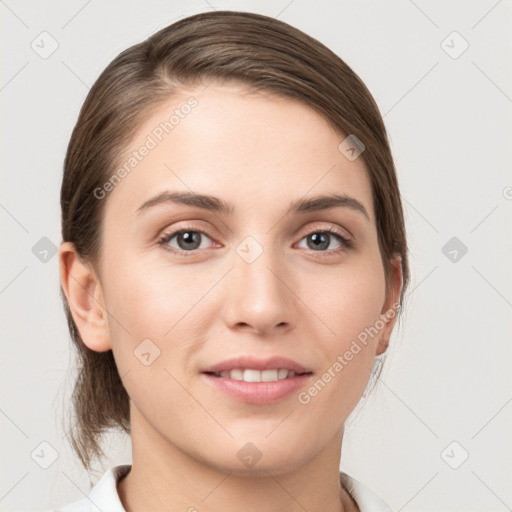 Joyful white young-adult female with medium  brown hair and grey eyes