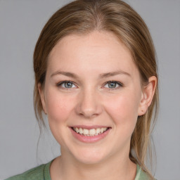 Joyful white young-adult female with medium  brown hair and blue eyes