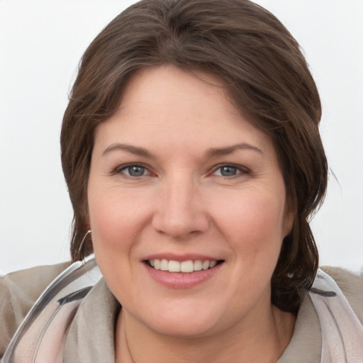 Joyful white young-adult female with medium  brown hair and grey eyes