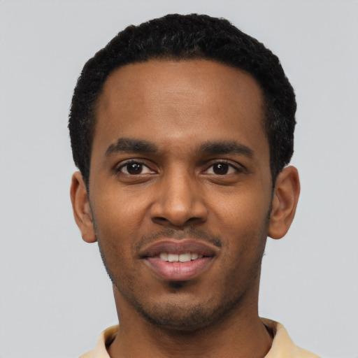 Joyful black young-adult male with short  black hair and brown eyes