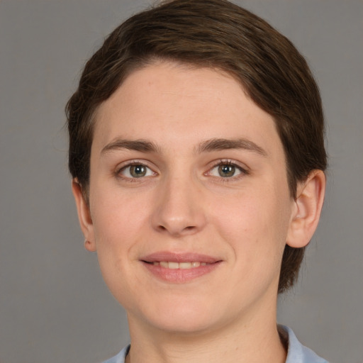 Joyful white young-adult female with short  brown hair and grey eyes