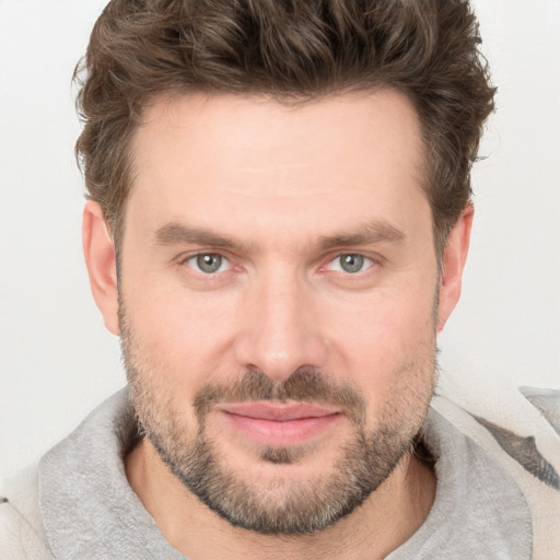 Joyful white adult male with short  brown hair and grey eyes