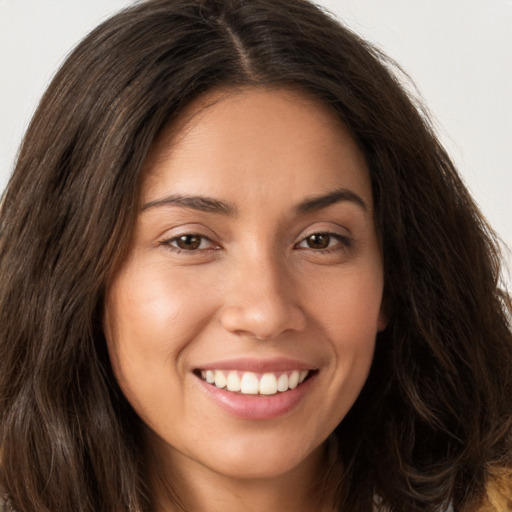 Joyful white young-adult female with long  brown hair and brown eyes