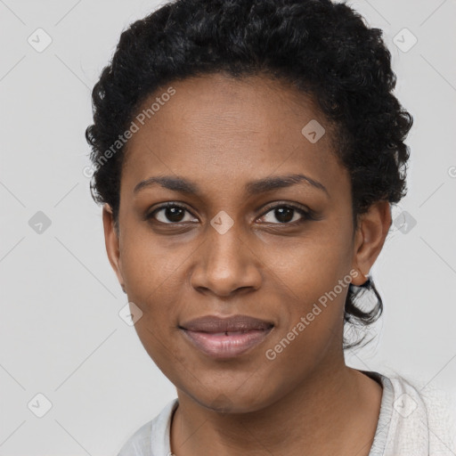 Joyful black young-adult female with short  black hair and brown eyes