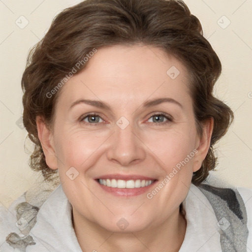 Joyful white adult female with medium  brown hair and blue eyes