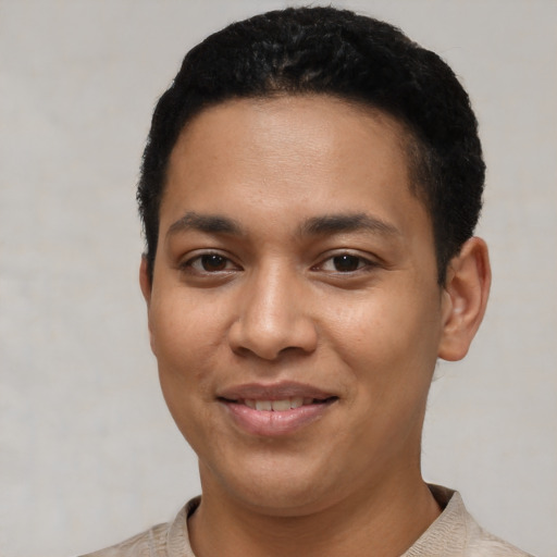 Joyful latino young-adult male with short  black hair and brown eyes