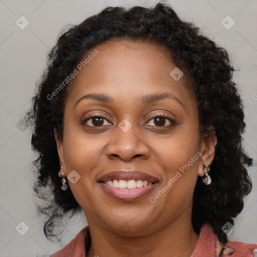 Joyful black adult female with long  brown hair and brown eyes