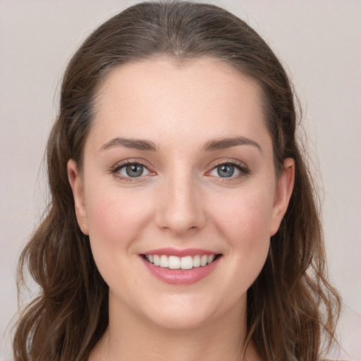 Joyful white young-adult female with long  brown hair and grey eyes