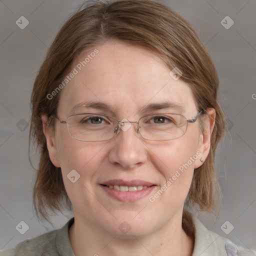 Joyful white adult female with medium  brown hair and blue eyes