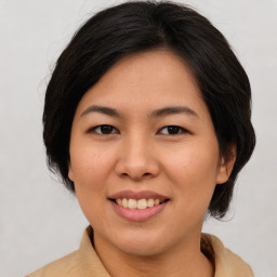 Joyful asian young-adult female with medium  brown hair and brown eyes